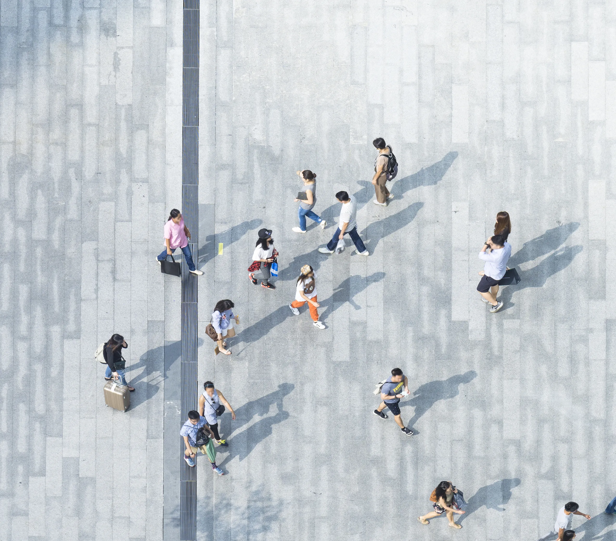 The photo features a group of people on a sidewalk.